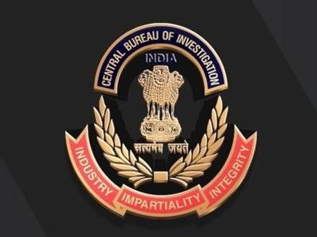 52400_1781679172 - The Journalist News Emblem of the Central Bureau of Investigation (CBI) with the Ashoka pillar, laurel wreath, and a red banner that reads 'INDUSTRY IMPARTIALITY INTEGRITY' around the edge.