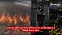 Fire on a storefront with flames while firefighters and a fire engine respond nearby; red news ticker at bottom.