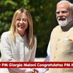 Italian Prime Minister Giorgia Meloni and Indian Prime Minister Narendra Modi shake hands outdoors during a formal greeting.