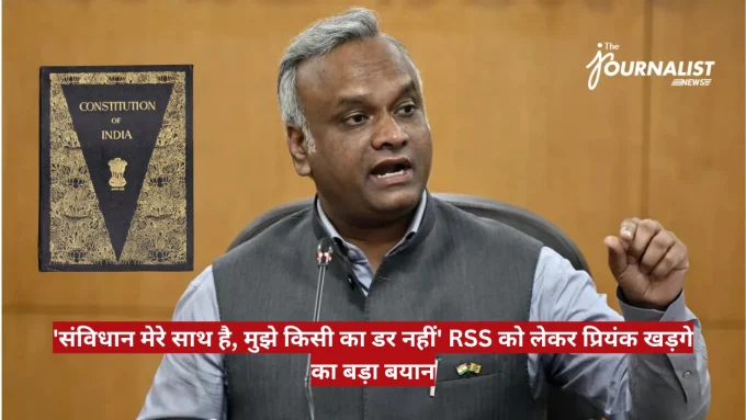 Man in a gray vest speaks at a microphone; Constitution of India book appears on the left.