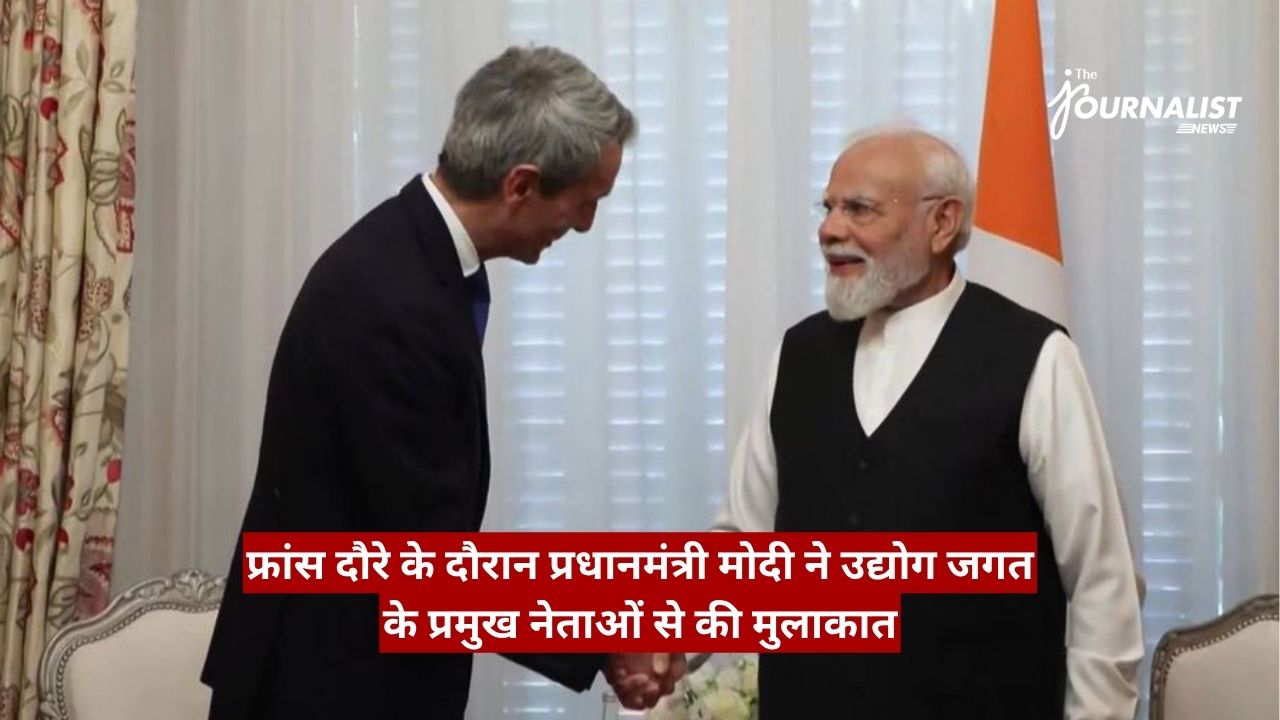 Two men in formal attire shake hands in a room, with a red Hindi news banner across the bottom and a flag in the background.