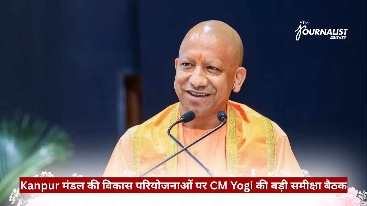 Public figure in orange robes speaking at a microphone on a stage, with a Hindi news banner across the bottom and a 'The Journalist' watermark in the top-right corner.