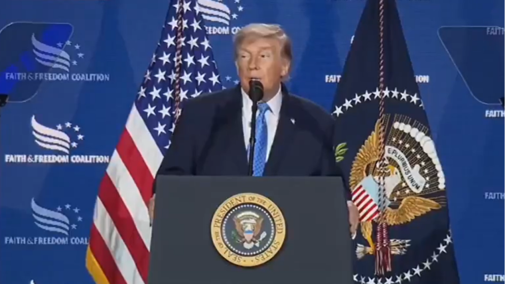 Former President Donald Trump delivers a speech at a podium with the presidential seal, flanked by the U.S. flag and a backdrop reading Faith & Freedom Coalition.