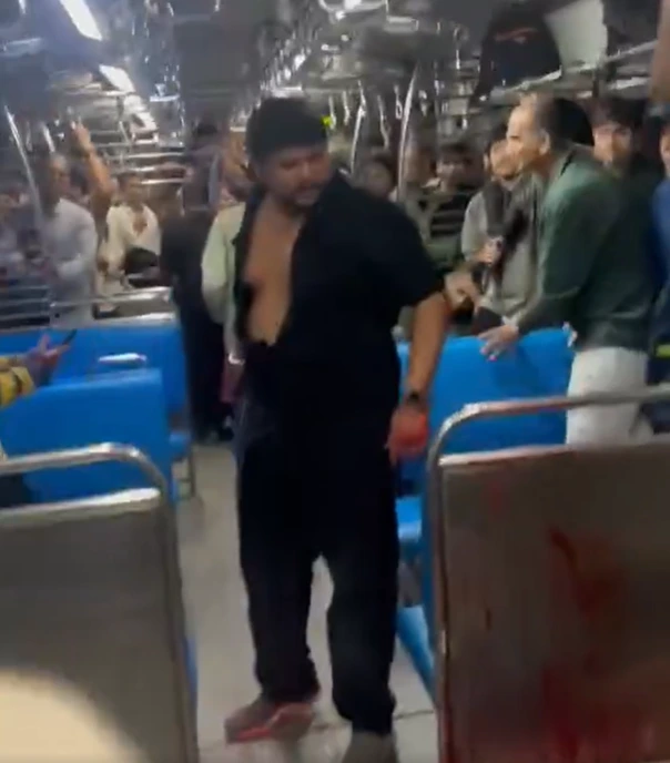 Screenshot 2026-06-24 141522 - The Journalist News Man in a black open jacket walking down the aisle of a crowded subway car.