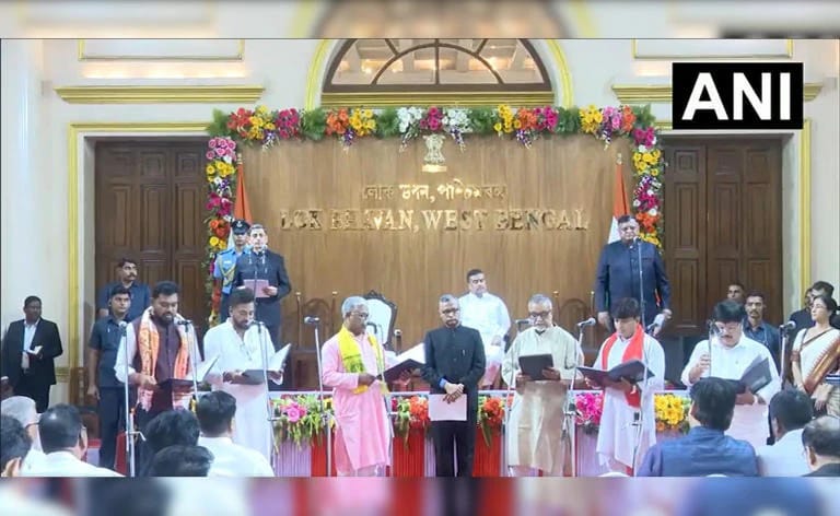 WhatsApp Image 2026-06-01 at 115541 PM - The Journalist News Ceremonial gathering at Lok Bhavan, West Bengal, with officials reading from documents on a flower-decorated stage.