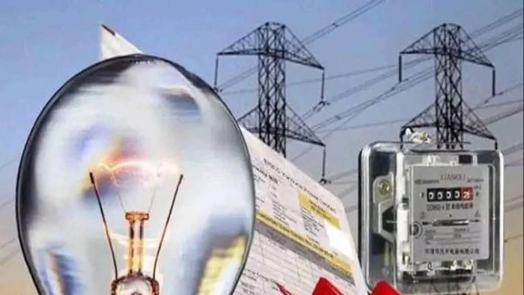 WhatsApp Image 2026-06-02 at 124606 AM - The Journalist News Close-up of a lit incandescent bulb with an electric meter and power lines in the background.