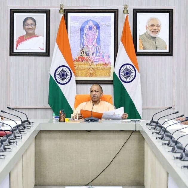 WhatsApp Image 2026-06-03 at 123046 AM 1 - The Journalist News Prime Minister Narendra Modi sits at a conference table with two Indian flags behind him and portraits on the wall behind.