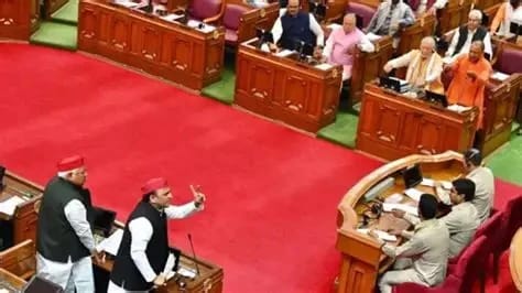 WhatsApp Image 2026-06-03 at 83957 PM 1 - The Journalist News Legislative chamber with two speakers at a podium addressing seated lawmakers on a red-carpeted floor in a parliamentary session.