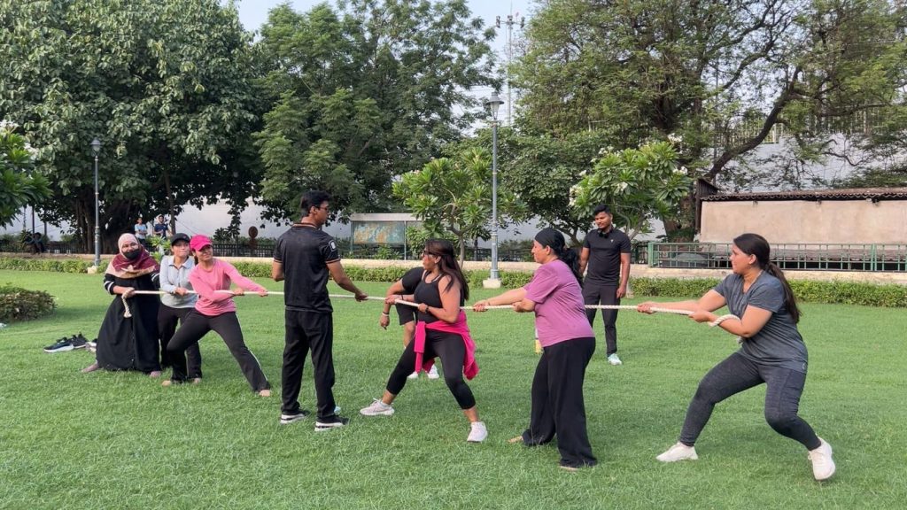 WhatsApp Image 2026-06-21 at 11402 PM 1 - The Journalist News Group of adults in a park engaged in a tug-of-war, pulling a rope side by side.