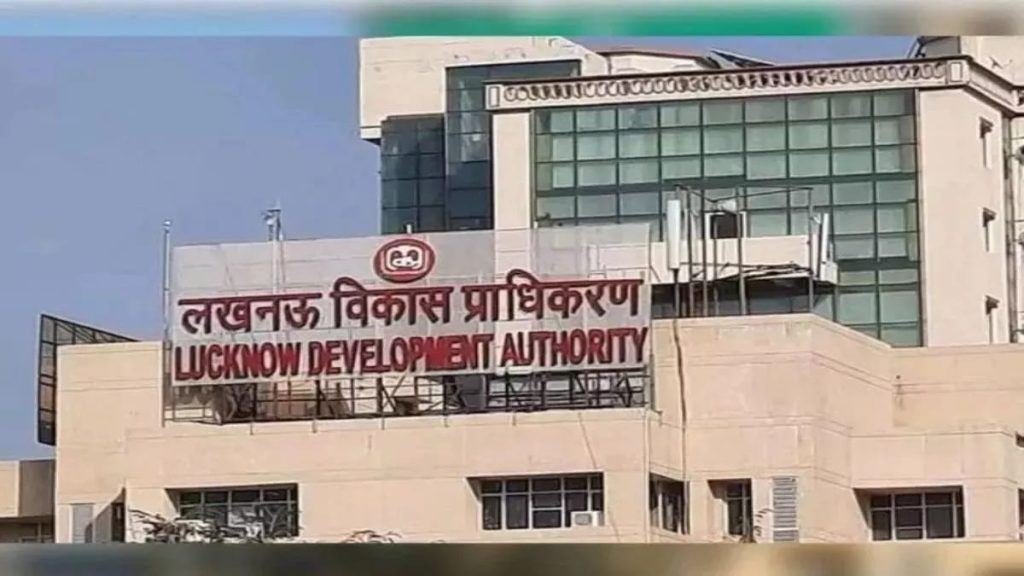 WhatsApp Image 2026-06-24 at 53005 PM - The Journalist News Rooftop banner on a beige government building reading 'LUCKNOW DEVELOPMENT AUTHORITY' in red letters, with Hindi text above.