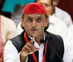 download 2 1 - The Journalist News Man wearing a red cap and black vest speaks into a headset microphone and points forward during a conference.