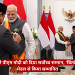 Indonesian official pins a medal on Indian Prime Minister Narendra Modi during a formal ceremony, with Indonesian and Indian flags in the background and a crest on the wall behind them.