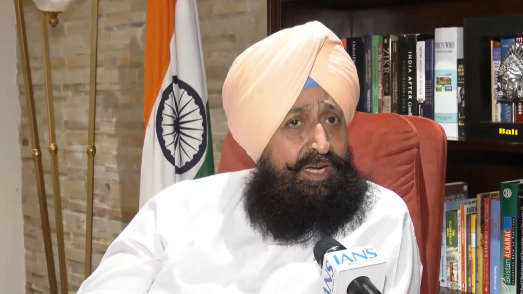 Light Blue and Yellow Bold Month Astrology Horoscope YouTube Thumbnail 24 - The Journalist News Bearded man in a peach turban sits in an orange chair during an interview, with an IANS microphone and the Indian flag in the background.