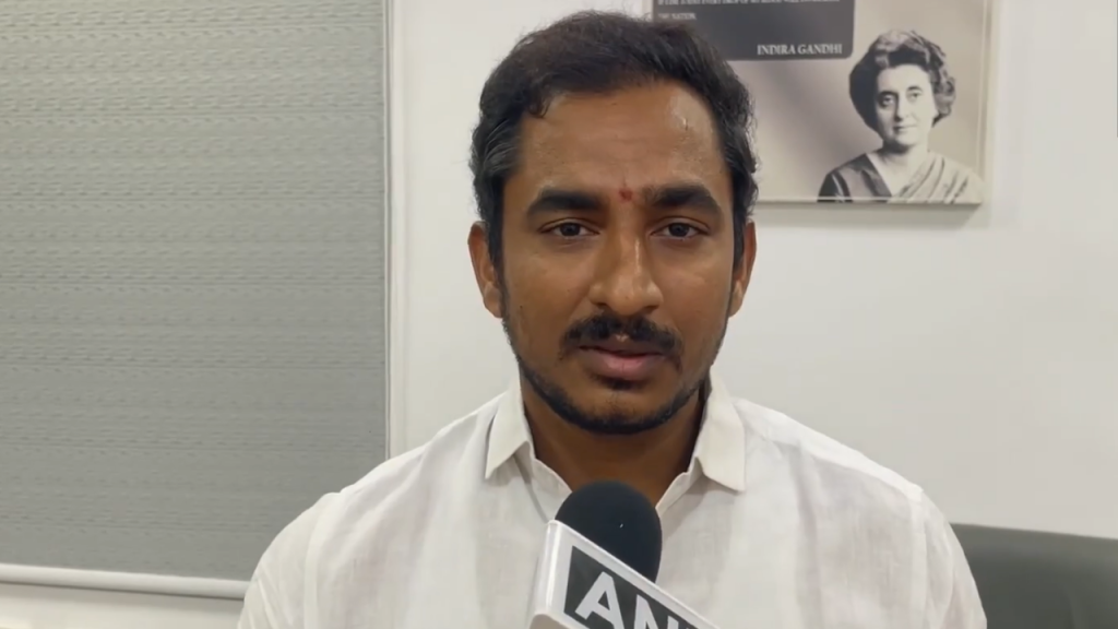 Thumbnail 3 - The Journalist News Man in a white shirt is interviewed, speaking into a handheld microphone labeled 'ANI' in a studio setting with a poster in the background.